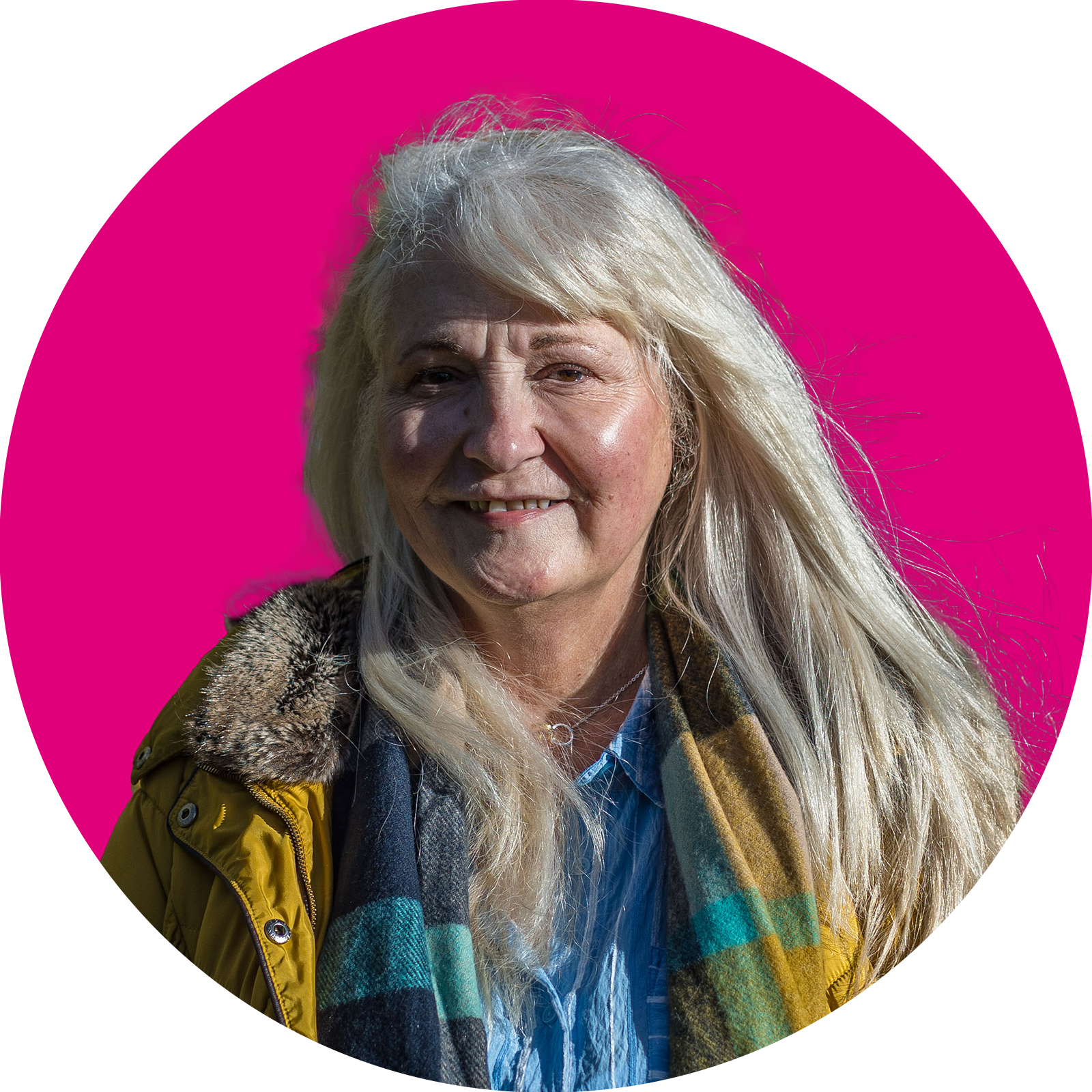 Portrait of a woman smiling with pink background