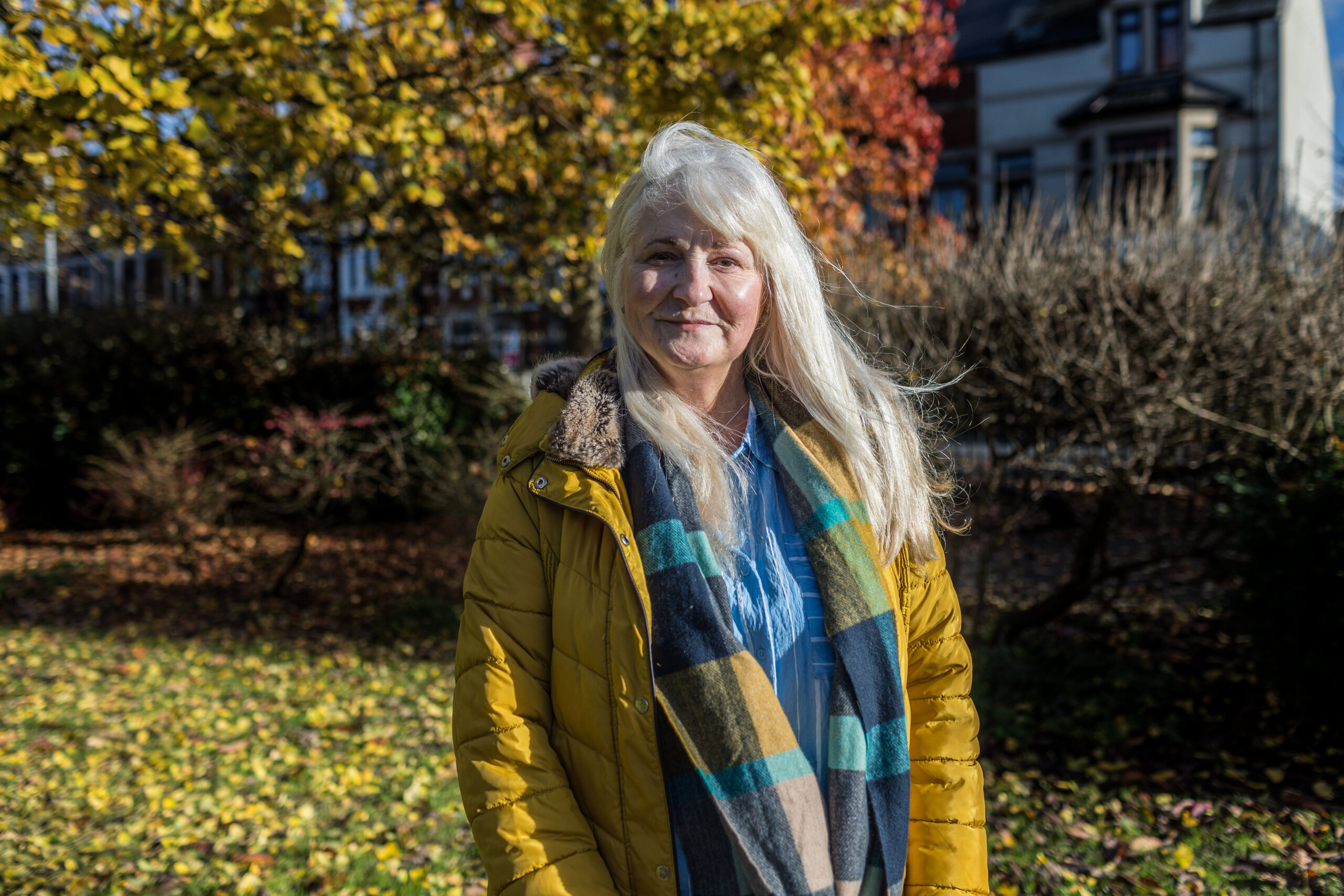 Portrait of a woman smiling with trees behind her